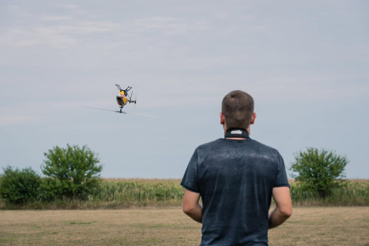 RC helicopter hovering low over the field at dusk
