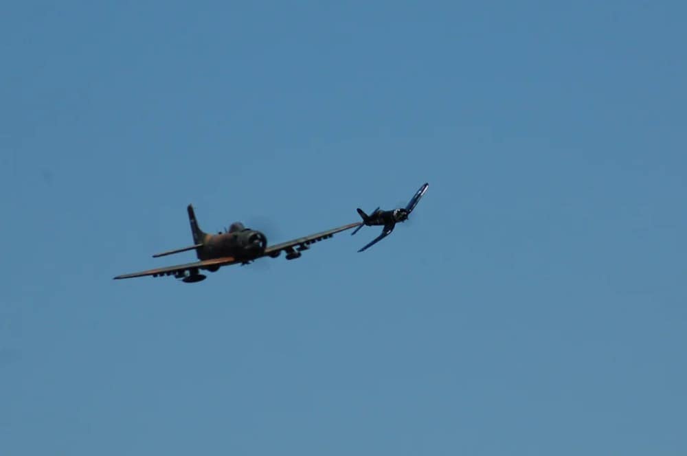 Two RC warbird models flying in formation