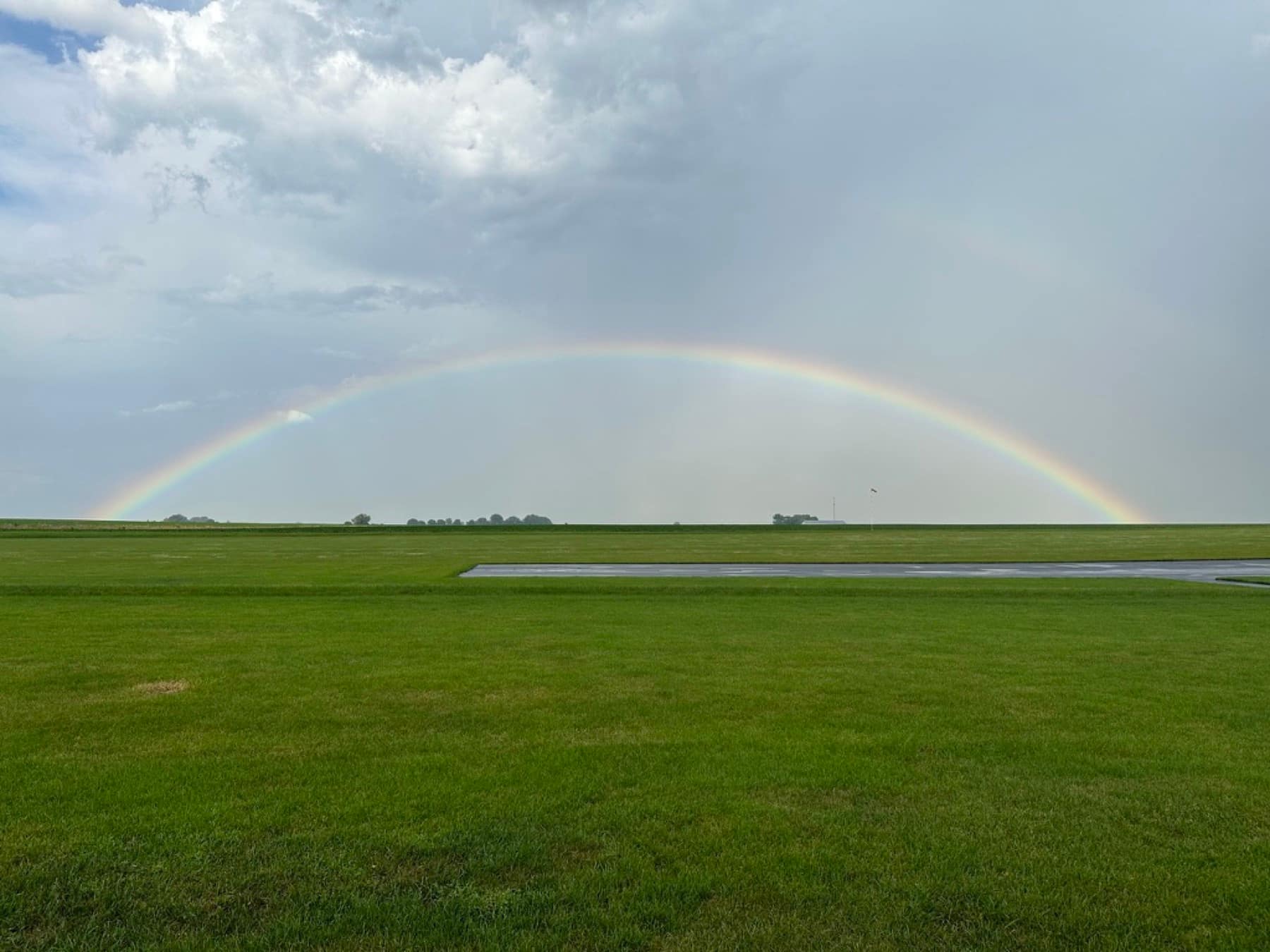 A double rainbow over the club's private grass field after a storm